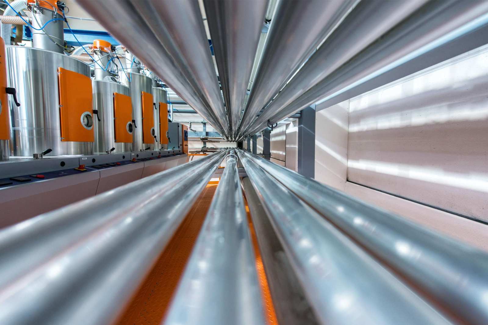 Rows of polished pipework running through a building services plant room